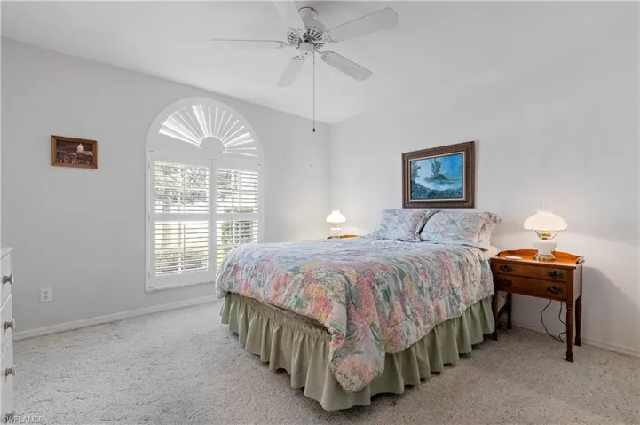 Bedroom featuring light carpet and ceiling fan