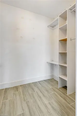 Walk in closet featuring wood tiled floors