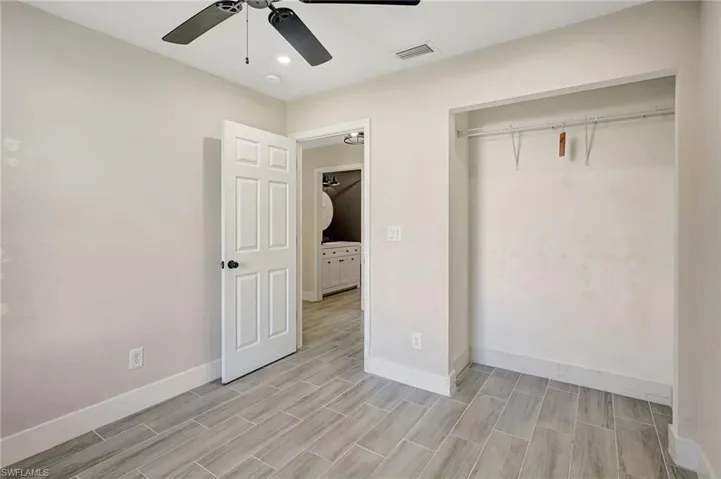 Unfurnished bedroom featuring ceiling fan, a closet, recessed lighting, and wood finish floors