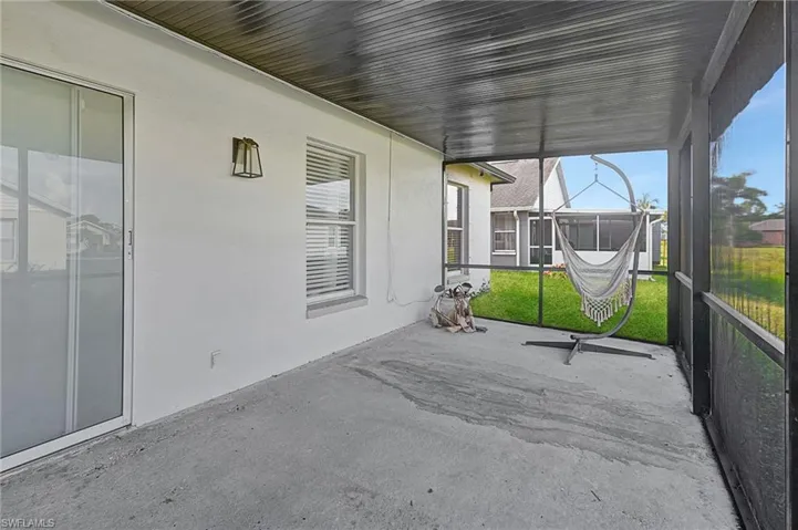 Unfurnished sunroom featuring a patio
