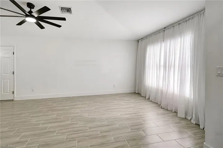 Empty room featuring wood finish floors and a ceiling fan