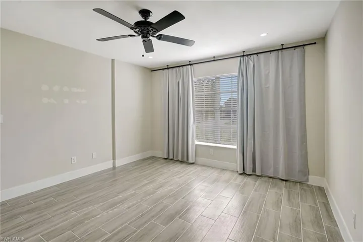 Spare room with ceiling fan, wood tiled floors, and recessed lighting