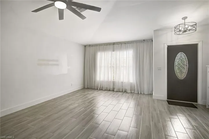 Entrance foyer with wood finish floors and ceiling fan
