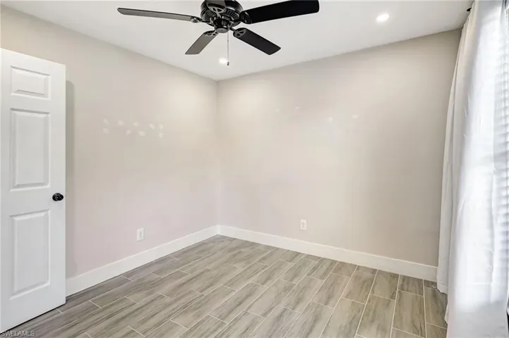 Unfurnished room featuring ceiling fan, recessed lighting, and wood tiled floors