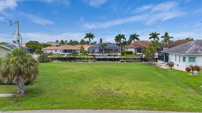 View of yard featuring a boat dock and a lanai