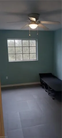 Unfurnished bedroom with baseboards and a ceiling fan