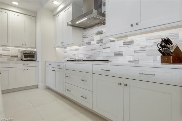 White cabinetry, quartz counter-tops, stainless appliances, beautiful backsplash, custom lighting -- you will appreciate every detail this home has to offer.