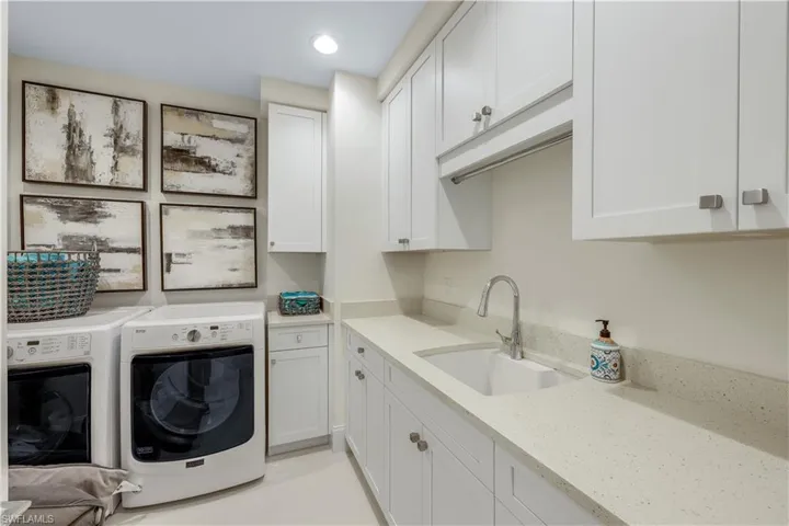 Large laundry room with tub and SO MUCH STORAGE space.