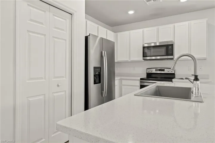 15346 Wildflower Circle Naples, FL 34119 - Kitchen with quartz countertop and large single bowl sink