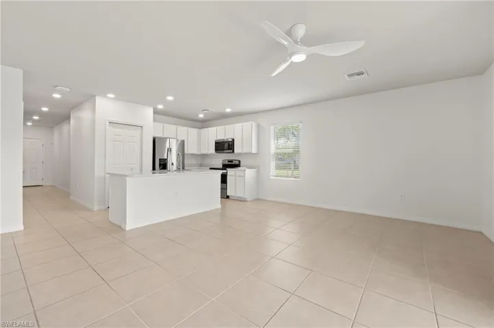 15346 Wildflower Circle Naples, FL 34119 - Lots of can lights and side window keep the living area bright.