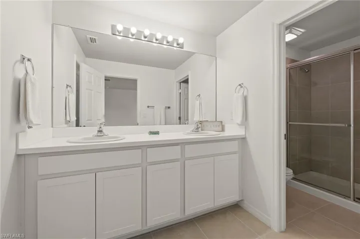 15346 Wildflower Circle Naples, FL 34119 - Owner's bath with private commode and walk in shower.