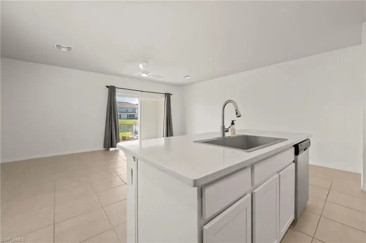 15346 Wildflower Circle Naples, FL 34119 - Open island kitchen with view out to lake