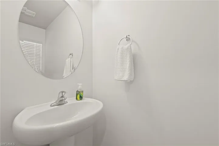 15346 Wildflower Circle Naples, FL 34119 - First floor powder room with pedestal sink