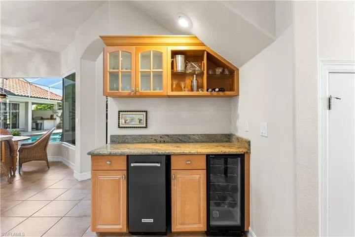 Your bar area has an icemaker and wine cooler. Custom glass cabinetry.