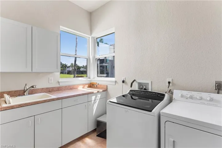 Large laundry room has storage, sink.