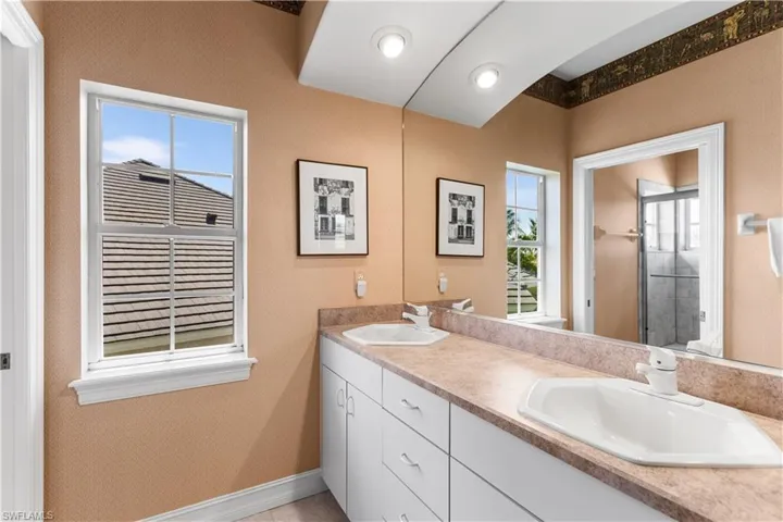 2nd bathroom is shared by the 2 upstairs bedrooms.  It has dual vanities, shower/tub combination.