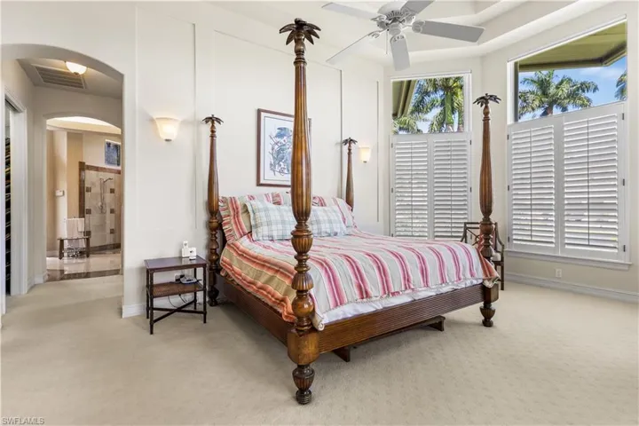 Your master wing offers double tray ceilings, custom plantation shutters, electric blinds above. Lush carpeting, sitting area.