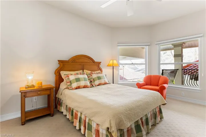 Located on the 2nd level, the 2nd bedroom has a private balcony overlooking the pool and courtyard area. Carpet.