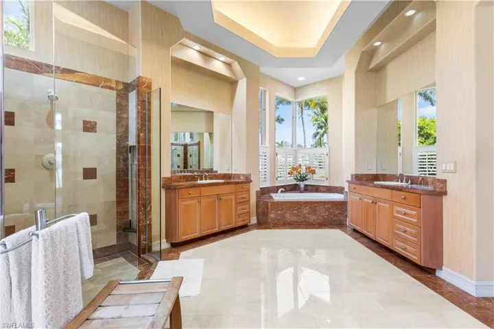 Your enormous master ensuite has a massive walk in shower, marble floors and walls, separate marble vanities and a separate soaking tub.  Uplighting in your tray ceiling.