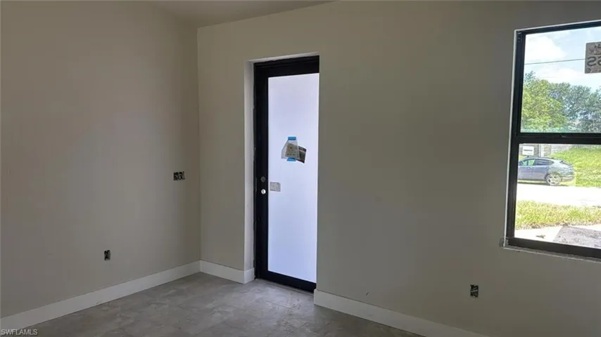 Empty room featuring baseboards