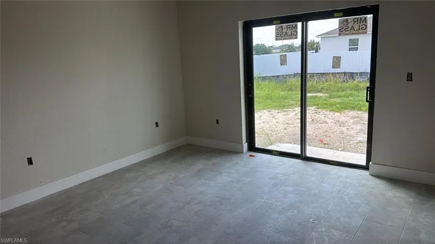 Unfurnished room featuring baseboards