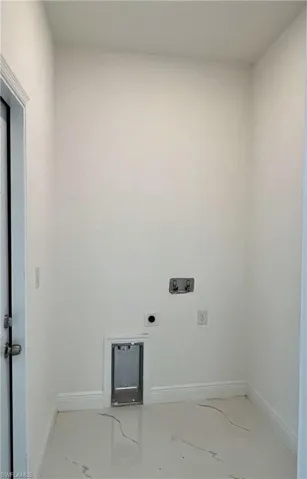 Clothes washing area featuring hookup for an electric dryer and hookup for a washing machine