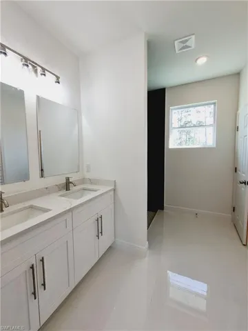 Bathroom featuring tile patterned flooring and vanity