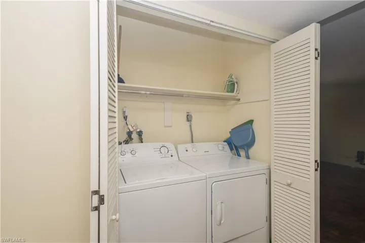 Laundry room with electric dryer hookup and washing machine and clothes dryer