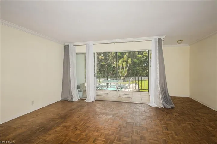 Unfurnished room with dark parquet floors and ornamental molding