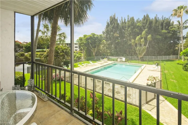 View of swimming pool with a lawn