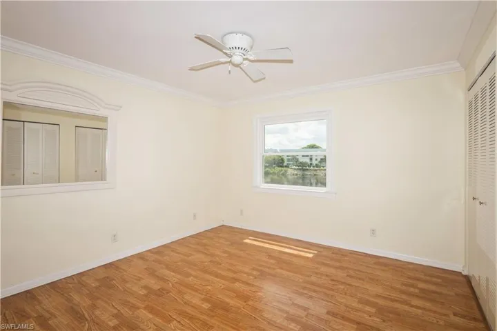 Master with hardwood / wood-style flooring, ornamental molding, and ceiling fan