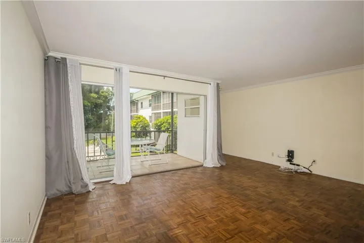 Unfurnished room with dark parquet floors and ornamental molding