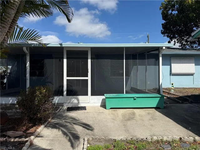 Back of property with a sunroom