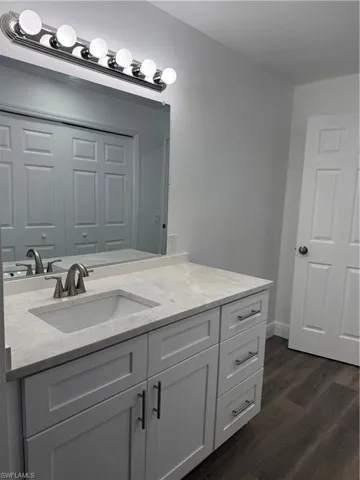 Bathroom featuring vanity and dark wood finished floors