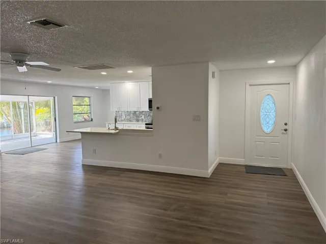Foyer with recessed lighting, dark wood-style floors, ceiling fan, and a textured ceiling