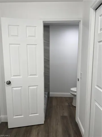 Bathroom with toilet and dark wood-style floors
