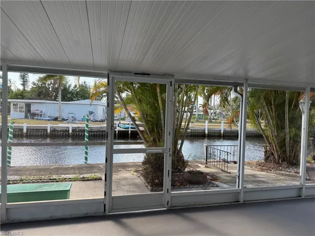 Unfurnished sunroom with a water view