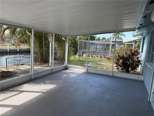 Unfurnished sunroom with a water view