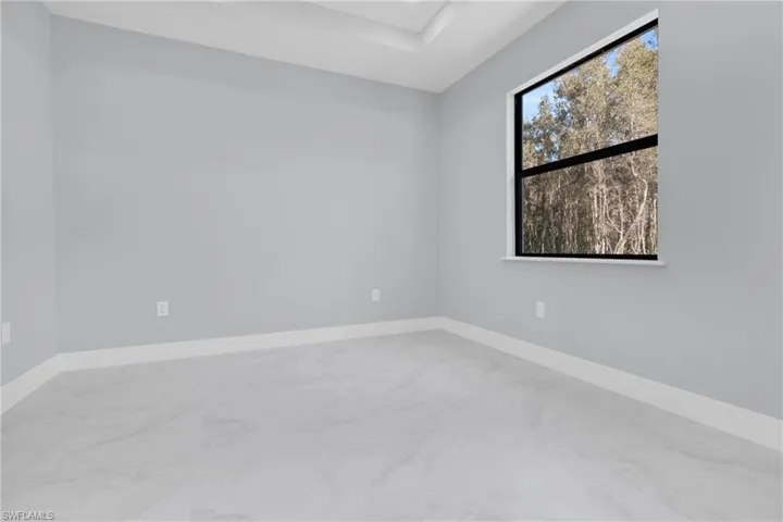 Unfurnished room with baseboards