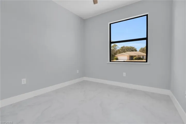 Spare room featuring light marble finish flooring and ceiling fan