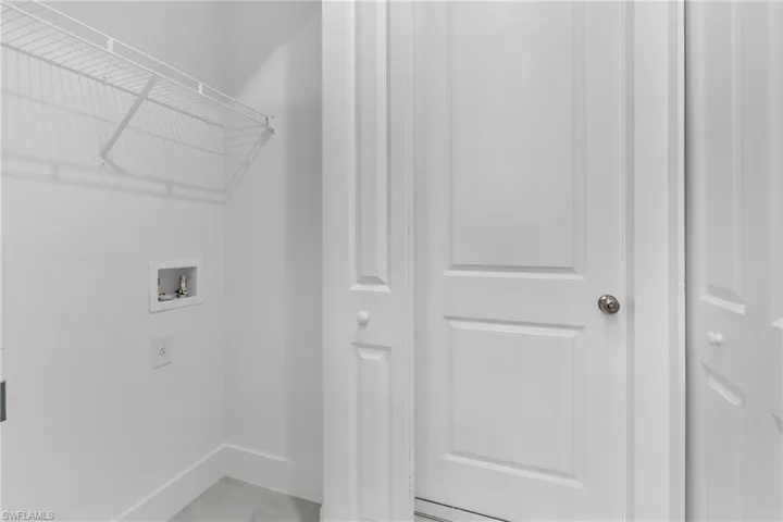 Laundry area with washer hookup and baseboards