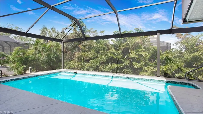 Outdoor pool with a sunroom and a lanai