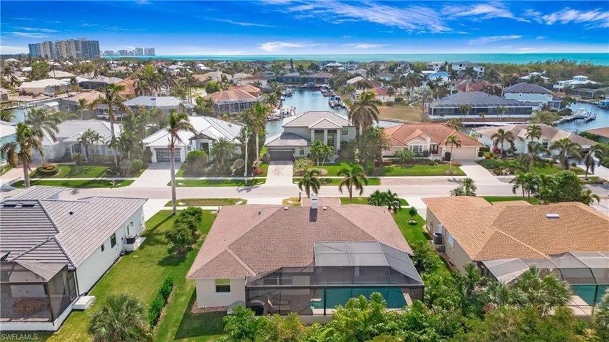 Aerial perspective of suburban area featuring a large body of water