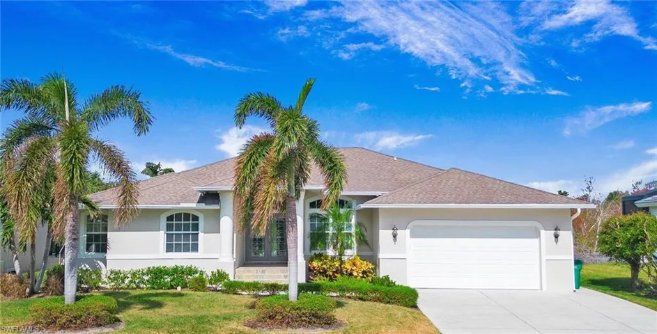 Ranch-style house with stucco siding, an attached garage, a shingled roof, and concrete driveway