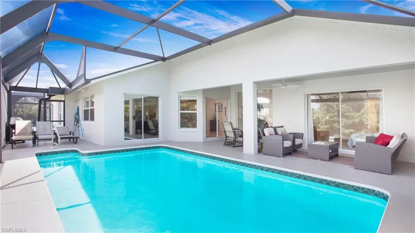 Swimming pool featuring a sunroom, outdoor lounge area, a lanai, and a patio area