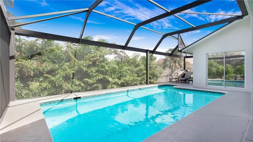 Outdoor pool featuring a lanai, a sunroom, and a patio