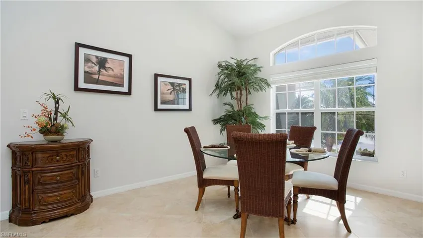 Dining area with baseboards and vaulted ceiling