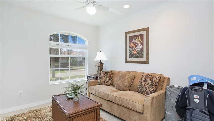 Living area featuring ceiling fan and recessed lighting