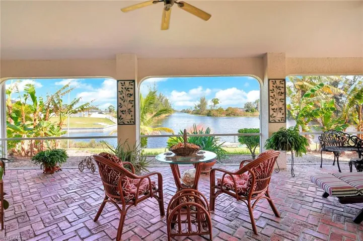 View of patio / terrace with a water view and ceiling fan