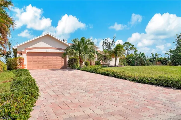 View of front of house featuring a front yard and a garage